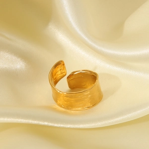 Macro shot of 18K gold plated wide ring featuring a unique hand-hammered texture finish