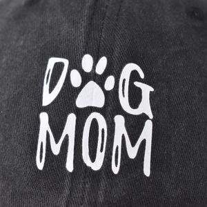 Black washed cotton baseball cap with white Dog Mom text and paw print embroidery