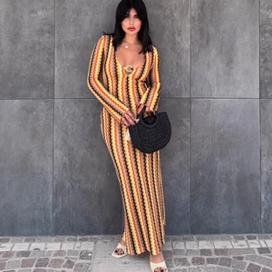 Slim fit V-neck long sleeve knit dress featuring vibrant zigzag patterns in warm tones