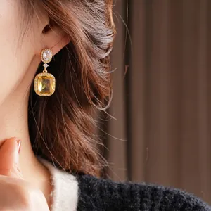 Vintage 18K gold plated earrings featuring yellow cushion-cut crystals and white zircons