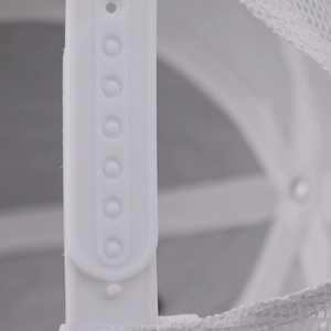 Detail of adjustable white snapback closure and mesh fabric on a trucker baseball cap