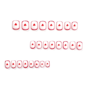 Short square press-on nails with red heart patterns and French gradient tips
