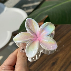 Iridescent plumeria flower hair claw clip with pink gradient center for women