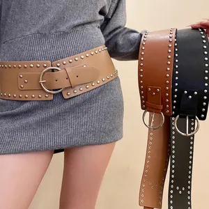Vintage wide leather waist belts with metal rivets and round buckles in khaki, brown, and black