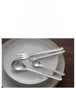 Detail of matte brushed 304 stainless steel cutlery set on a ceramic plate