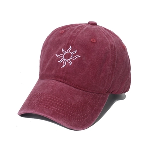 Maroon washed cotton baseball cap with white sun embroidery in a 45-degree angle view