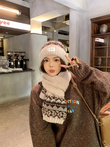 Detail of Fair Isle knit beanie and matching scarf set with soft warm winter texture