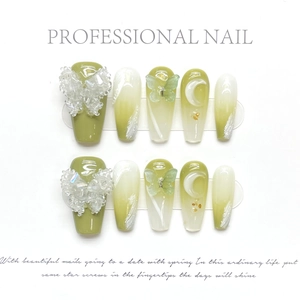 Detail of green gradient press-on nails with 3D crystal butterflies and moon relief