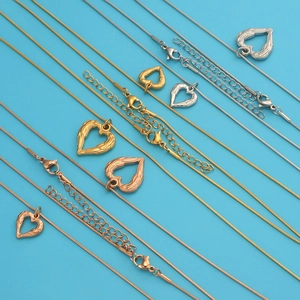 Detailed view of angel wing heart necklaces in gold, silver and rose gold finishes