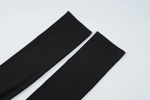 Detail shot of black knitted fabric sleeves with high elasticity and fine texture finish