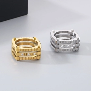 Detail of square layered punk gear rings in gold and silver with inlaid zircons