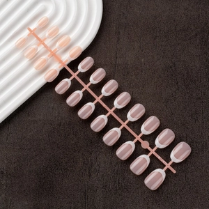 Macro shot of 24pcs nude and light brown French press-on nails with white tips