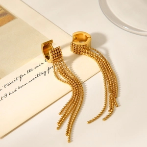 Macro view of gold stainless steel hoop earrings with delicate beaded chain tassels