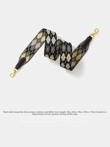 Detail of woven 5cm wide bag strap with black and gold rhombus pattern and leather ends