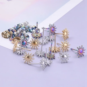 Detail of sunburst stud earrings in gold, silver, and rainbow finishes with butterfly backs
