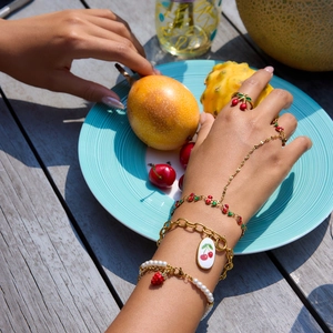 Model wearing 18K gold-plated fruit charms bracelets and cherry ring for summer beach