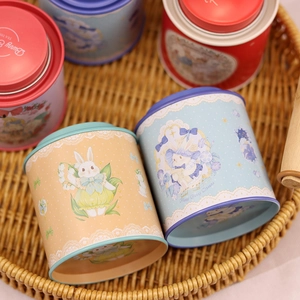 Round tin storage canisters featuring cute bunny and flower patterns in a woven tray