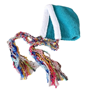 Ethnic style winter beanie with colorful tassels and soft plush trim in teal color