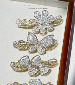 Detailed close-up of sparkling white crystal butterfly and flower alloy hair clip set