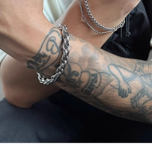 Close-up of men's chunky silver titanium steel hip hop rope chain bracelet on wrist