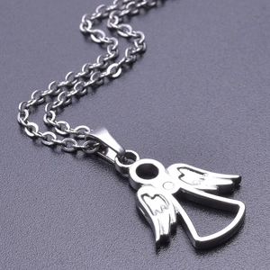 Macro shot of silver angel wing pendant showing detailed texture on polished stainless steel