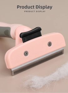 Detail showing the stainless steel teeth of the pink pet de-shedding comb with white fur
