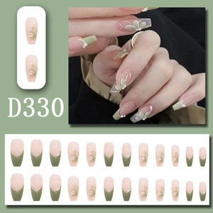 Detail of long ballerina press-on nails with camellia flowers and pearl accents