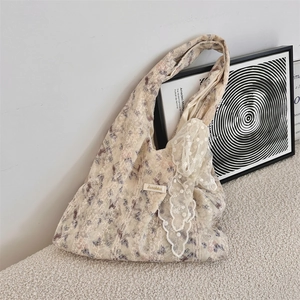 Detailed close-up of floral tote bag featuring lace trim and vintage purple flower prints