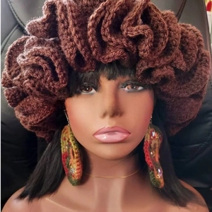Close-up of brown hand-knitted ruffle hat and matching sequined earrings set