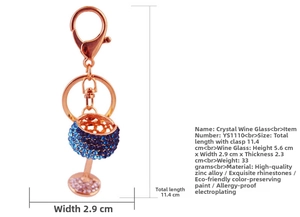 Detail of rose gold keychain featuring a crystal-studded wine glass with blue rhinestones