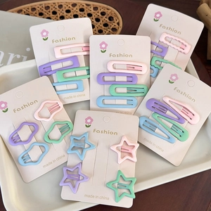 Set of pastel cream hair clips in star and cloud shapes on a decorative tray