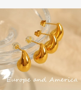 Macro shot of 18K gold plated teardrop earrings with a polished mirror finish detail