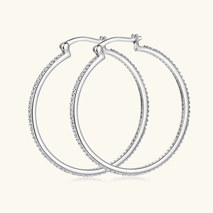Detailed view of large silver hoops with micro-set sparkling crystals in a modern style