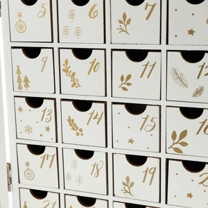 Close-up of white wooden Advent calendar drawers with gold numbers and Christmas patterns
