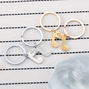 Split musical note puzzle keychains in gold and silver stainless steel for couples