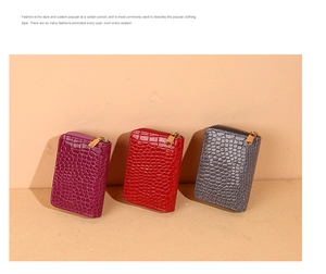 Detailed view of three glossy crocodile pattern card holders in purple, red, and grey tones