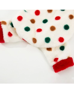 Detail of soft fleece pet clothing with colorful polka dots and red plush hem