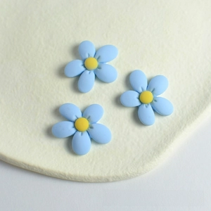 Close-up of sky blue resin peach blossom flower charms for DIY hair accessories crafts