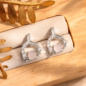 Silver fishtail earrings with pink zircon stone in a luxury jewelry box setting