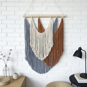 Bohemian hand-woven wall tapestry with colorful cotton tassels on a wooden rod for home decor