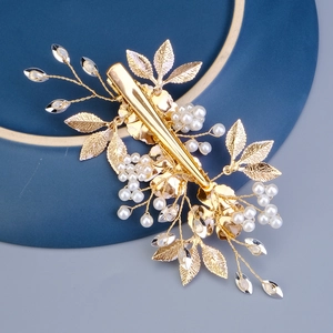Golden bridal hair clip with metal leaves, white pearls and sparkling crystals