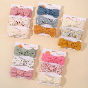 Detailed view of floral cotton baby headbands in a three-piece set with soft bow knots