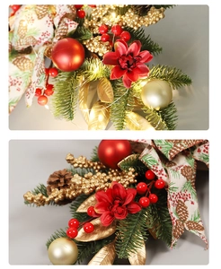 Close-up of Christmas swag with red berries, pine cones, gold baubles, and LED lights