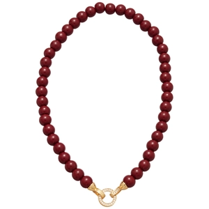Deep red beaded necklace with a gold zircon encrusted round pendant in a retro style