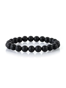 Detailed view of matte black volcanic stone beaded bracelet with reflection on white background