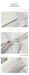 Macro details of white leather bag featuring metal chain strap and magnetic snap closure