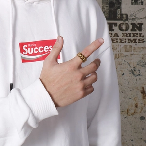 Close-up of men's gold stainless steel watch band chain ring worn on the index finger