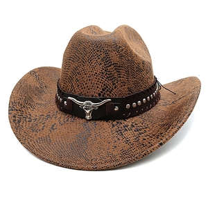 Detail of western cowboy hat with faux snakeskin texture and silver bull head emblem