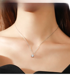 Close-up of S925 sterling silver necklace featuring a six-prong set solitaire diamond