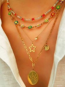 Detailed layered necklace set with colorful beads, enamel flowers, and gold M-pendant